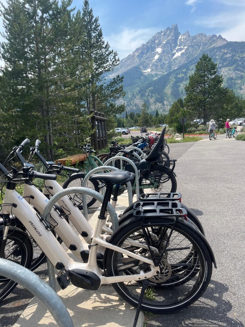 E-bikes parked at a trailhead below the Tetons