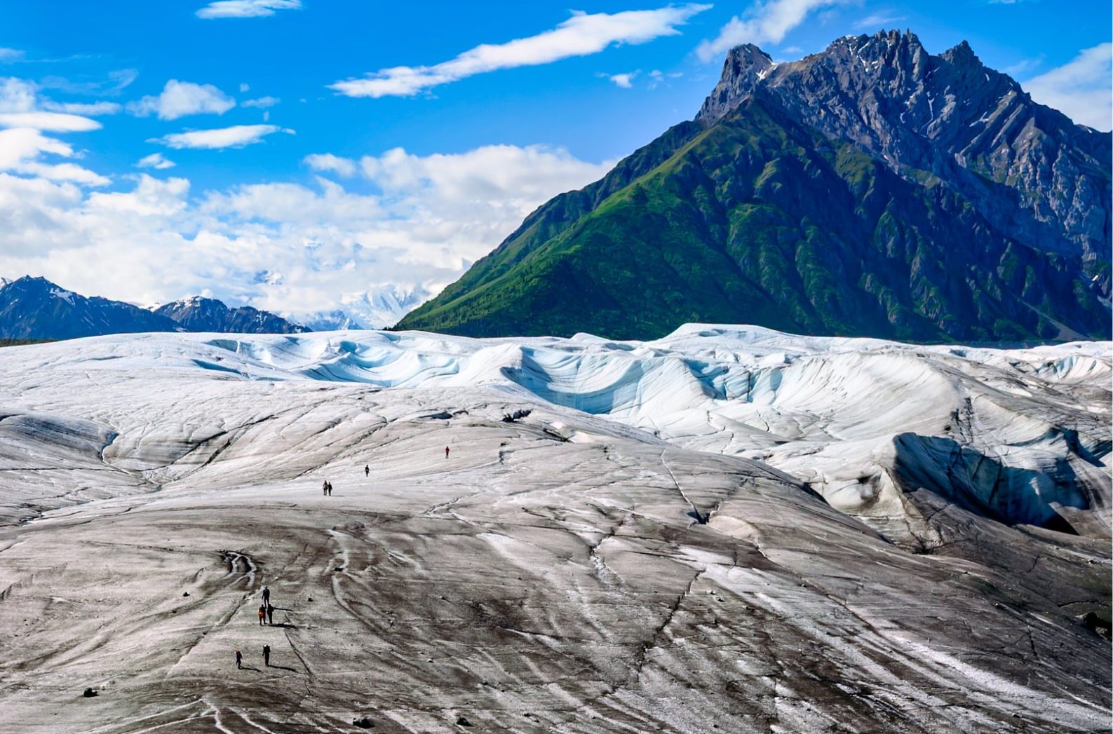 Hikers crossing the Root Glacier below the Wrangell Mountains, Alaska